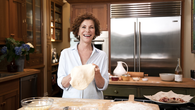 Joanne preparing food in her kitchen.